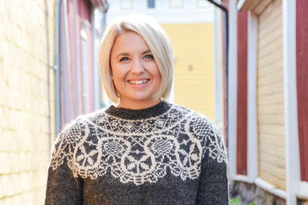 A woman wearing a Rauma sweater.