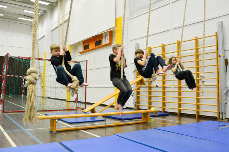 Kids swinging on ropes.
