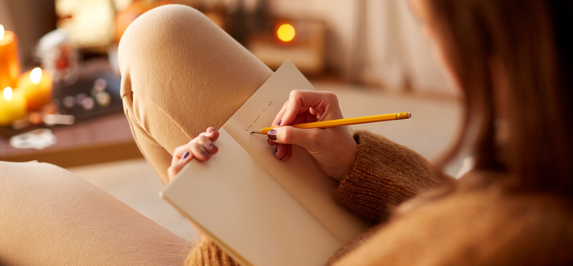 Person writing in diary.