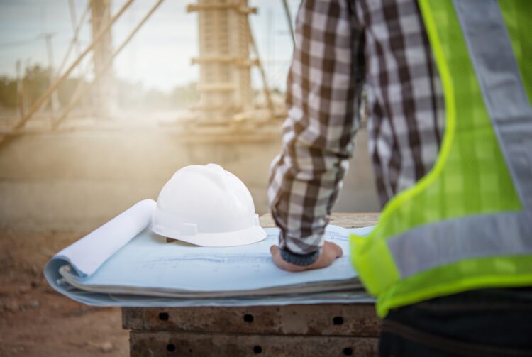 Building plans and a hard hat.