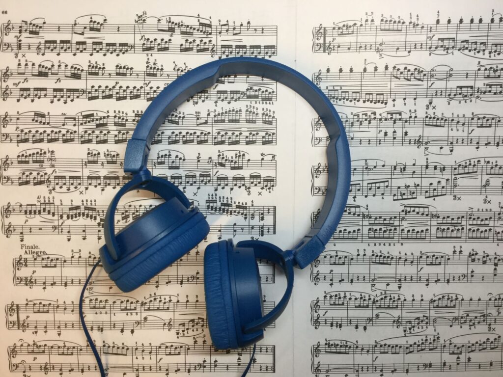 Headphones on top of the sheet music.