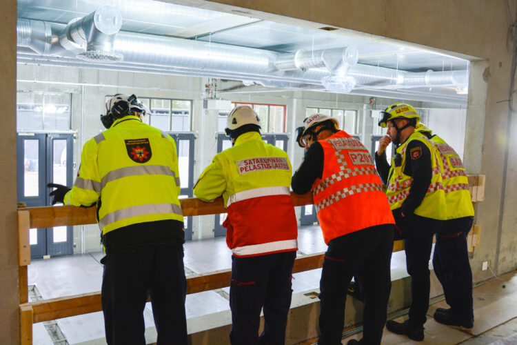 Firehouse personnel leaning over the railing at the firehouse.