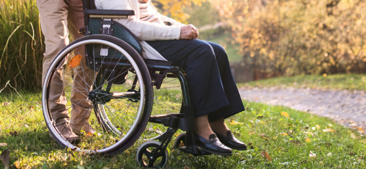 Old person sitting on a wheelchair.