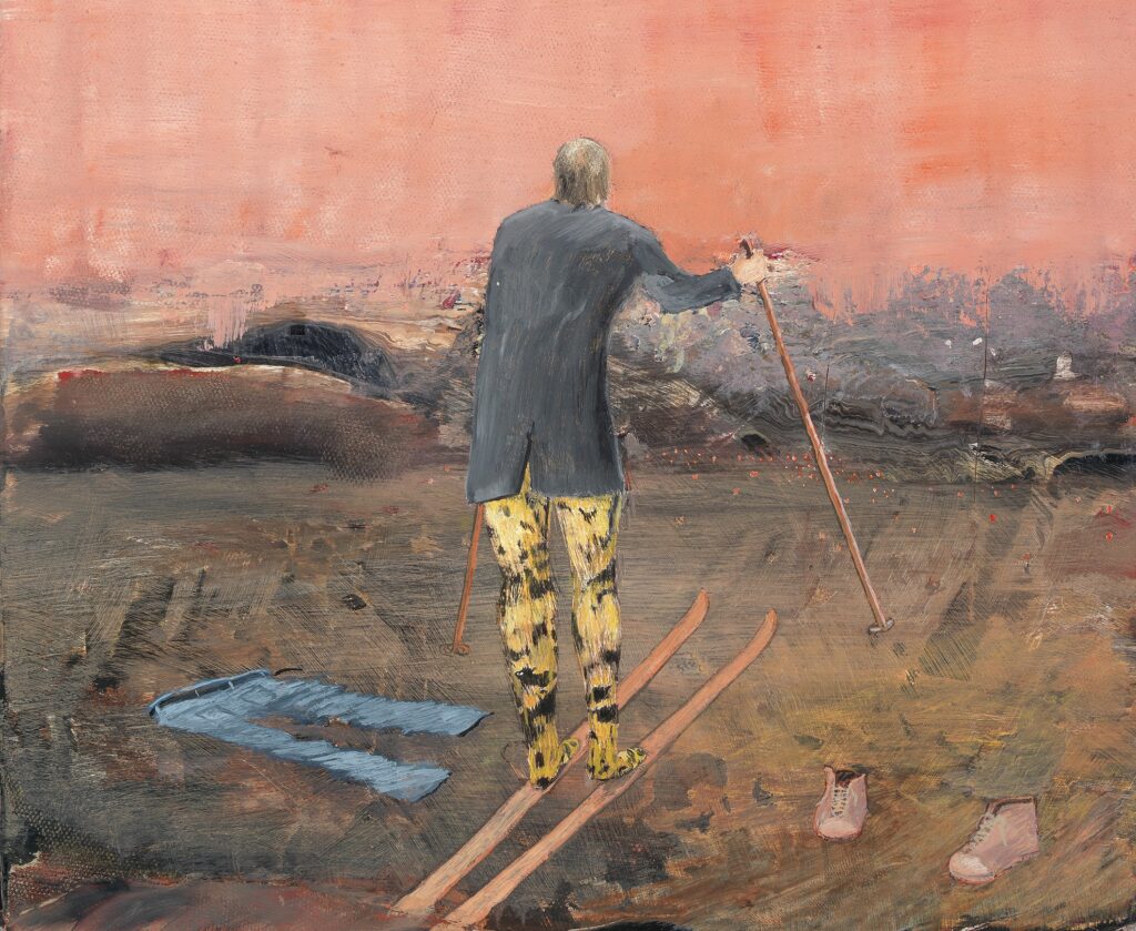 A man stands with his back to the viewer, wearing skis. There is no snow on the ground. His legs have a leopard-print pattern, and next to him on the ground are a pair of jeans and shoes. The landscape is suggestive.