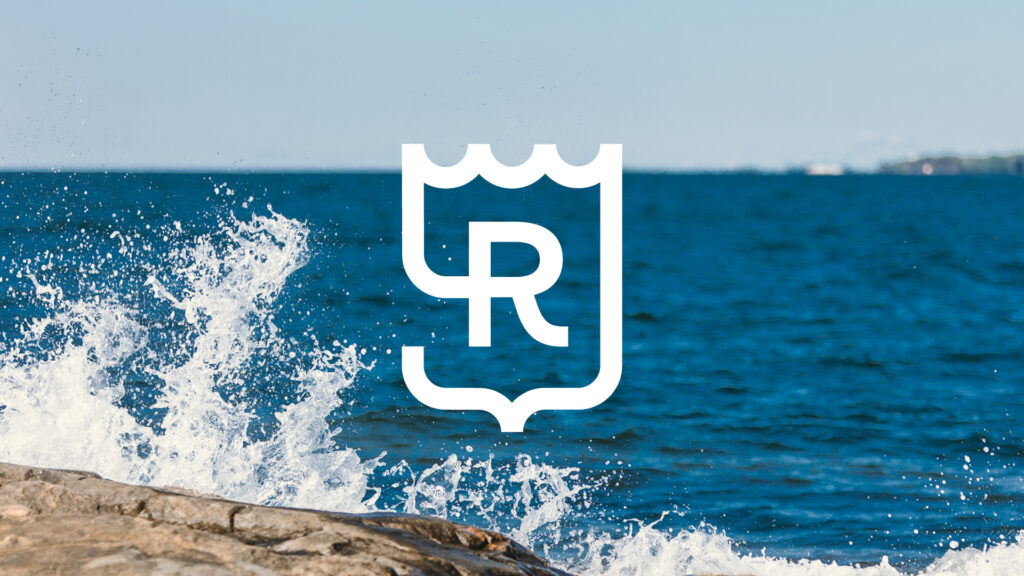 The image shows the winning maritime logo from Rauma’s logo vote. In the background of the logo, there is an image of the sea and crashing waves.