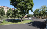 Photo of the ice park built next to the renovated Central Park. During the summer, the area features skate park elements. The image shows trees and skateboarding equipment.
